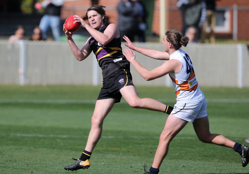 GOOD HANDS: Young Wodonga forward Hudson Garoni marks strongly for the Murray Bushrangers. The Bushrangers went down by 20 points. Pictures: KYLIE ESLER
