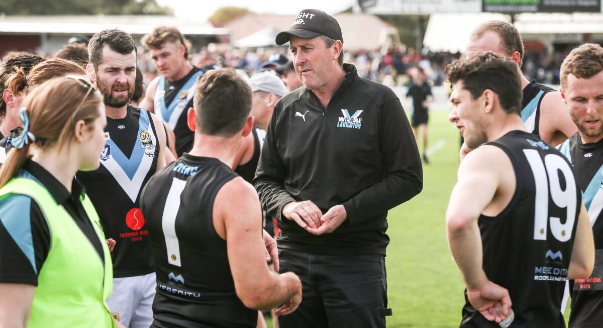 Former Lavington coach Tim Sanson talks tactics with some of the Panther forwards during the quarter-time break.