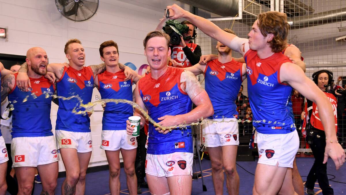 Charlie Spargo is swamped by his Melbourne teammates after the match.