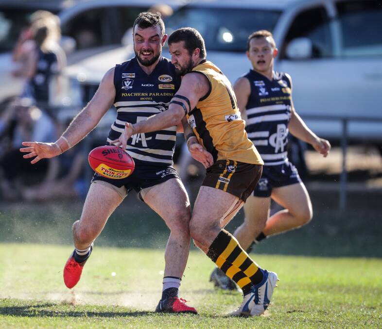 Rutherglen's Josh Warren shakes off a tackle to drive his team forward. The Cats are undefeated after three rounds.