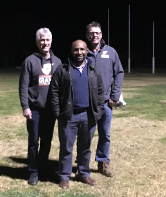 BACK IN TOWN: Rand-Walbundrie-Walla co-presidents Noel Garlick and Allan Thomas caught up with former player Walter Yangomina on Saturday. Picture: NAT BEDDOES