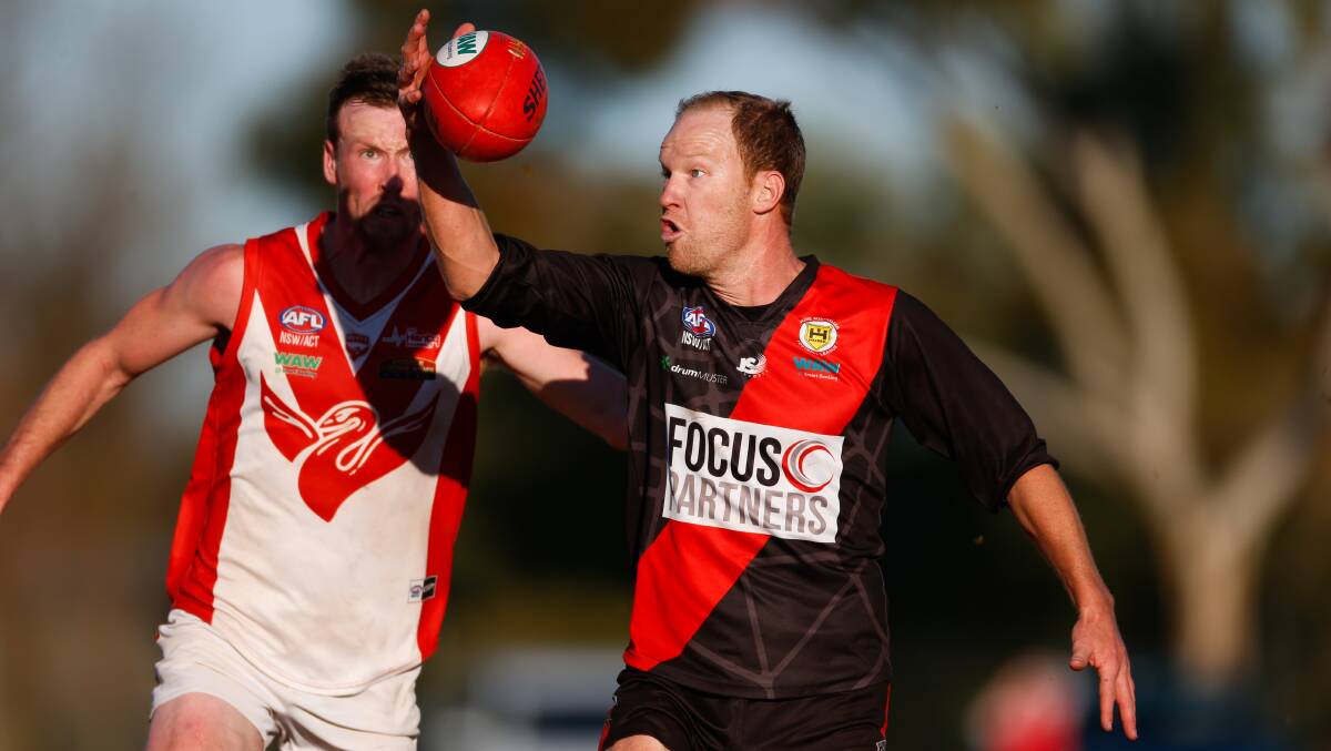 Price tries to evade a Henty opponent during his time at the helm of Howlong in 2015.