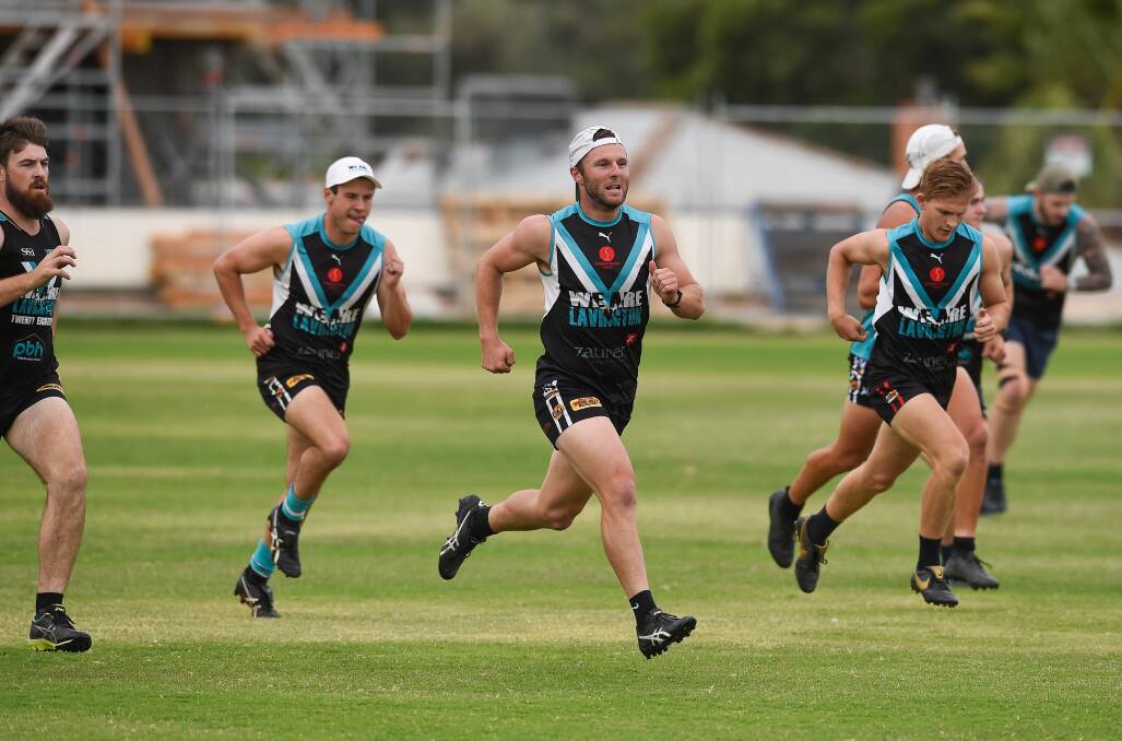 Forward Andrew Mackinlay and Henty recruit Jono Male lead the way during a training drill at Lavington this week. Picture: MARK JESSER