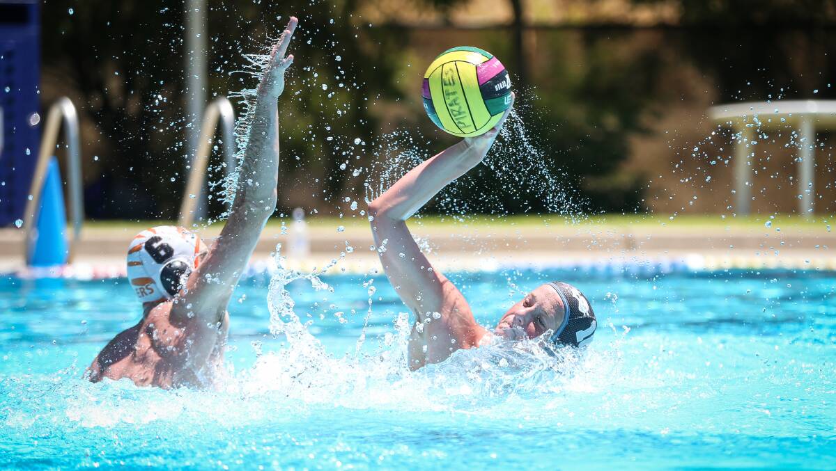 ON THE ATTACK: Pirates' Will Murphy and Albury's Harrison Evans do battle in Ovens and Murray water polo on Sunday. Picture: JAMES WILTSHIRE
