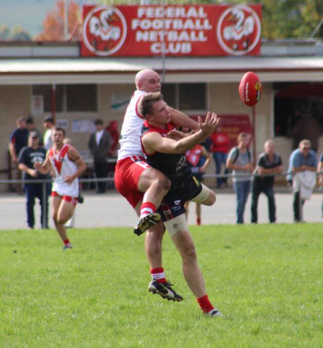 UNDER PRESSURE: Federal's Cam Tyrell spoils Corryong forward Nathan Grimes in the opening round at Corryong on Saturday. Picture: CORRYONG COURIER