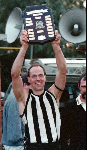 Coach Simon Hore holds the 1996 premiership trophy aloft. The Magpies dominated the Upper Murray in the 1990s.