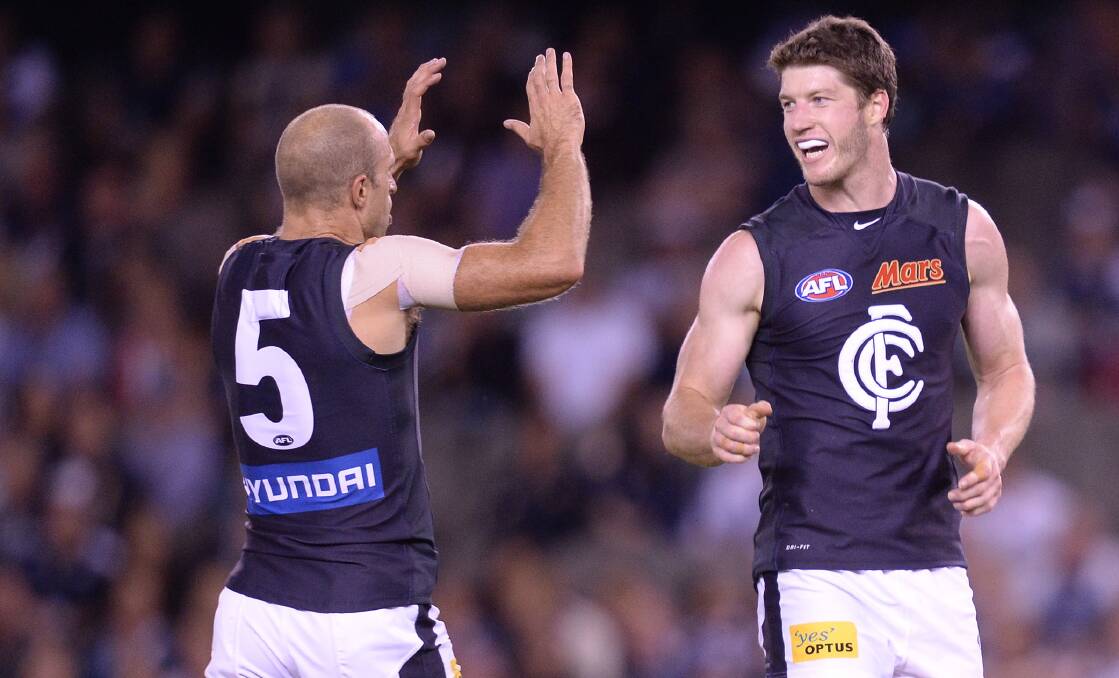 Carlton champion Chris Judd celebrates one of Sam Rowe's 17 goals for the Blues. He will play his 100th AFL match when he debuts for St Kilda on Saturday.