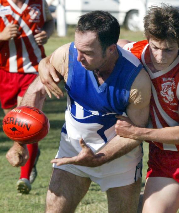 THIRSTY WORK: Robbie Martin is pinned in a tackle against Burrumbuttock in 2005.