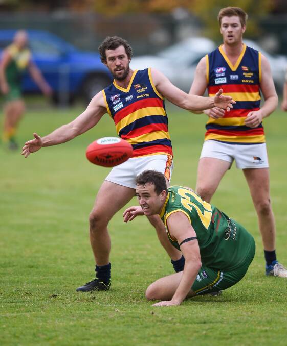 Billabong Crows coach Al Austin tangles with Brooker forward Andrew Dess at Holbrook on Saturday. Picture: MARK JESSER