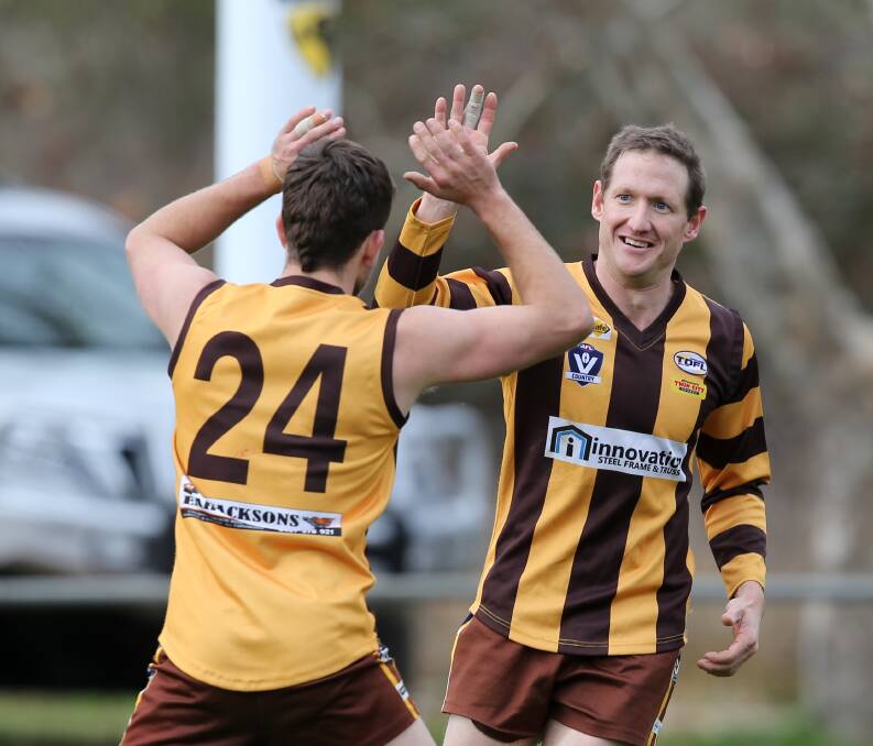Max Tittensor and Mal Vogel celebrate one of the home team's goals.