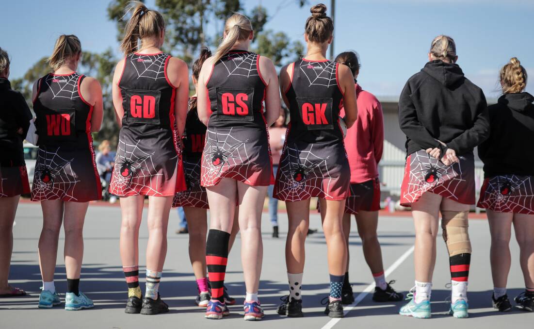 Howlong players line-up in their odd socks before Saturday's match against Osborne.