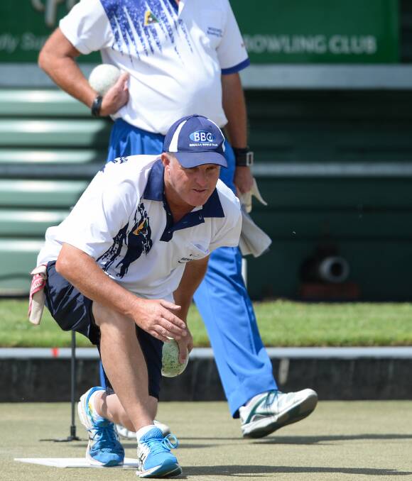PICTURE OF CONCENTRATION: Skip Matt Robertson sends down a bowl for Benalla at Wodonga on Saturday. The Bulldogs won by 18 shots to remain undefeated after five rounds. Picture: MARK JESSER