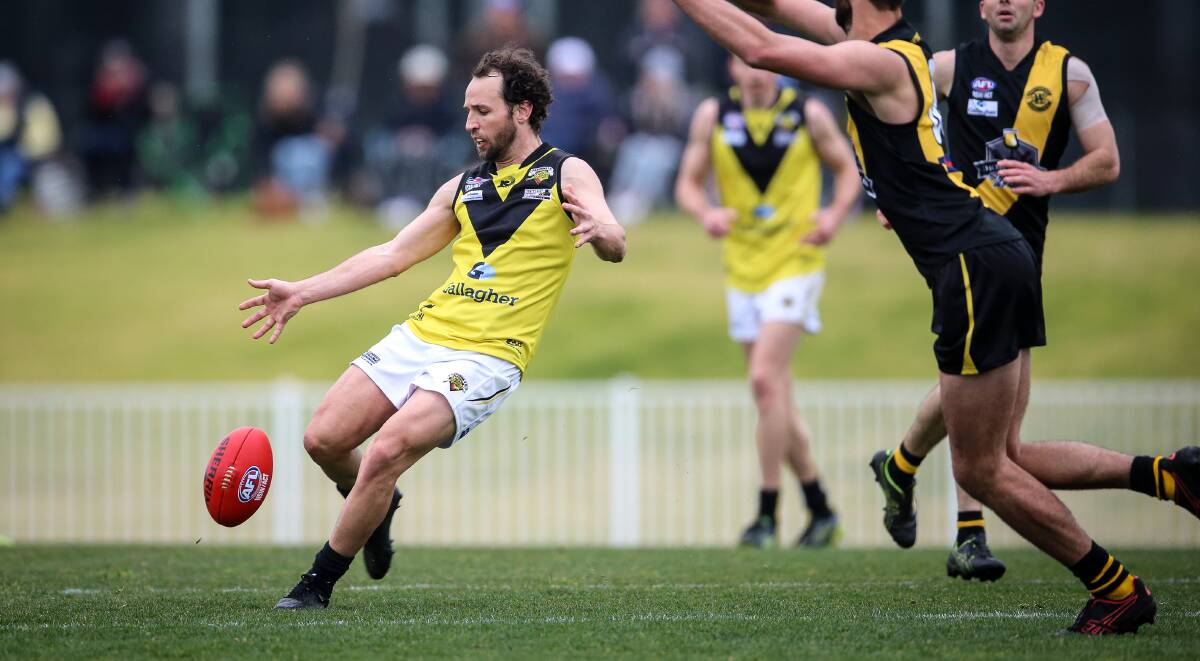 Osborne workhorse Marty Bahr gets a kick away under pressure against Wagga Tigers on Saturday. He kicked a telling goal in the third quarter from a 50-metre penalty.