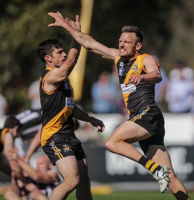 Albury veterans Joel Mackie and Dean Polo celebrate a goal at Wangaratta's Norm Minns Oval on Sunday. Picture: JAMES WILTSHIRE