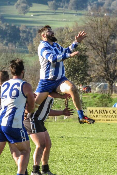 Tumbarumba's Travis Collison soars high for a mark against Border-Walwa on Saturday. The Roos take on Federal this weekend. Picture: WENDY LAVIS