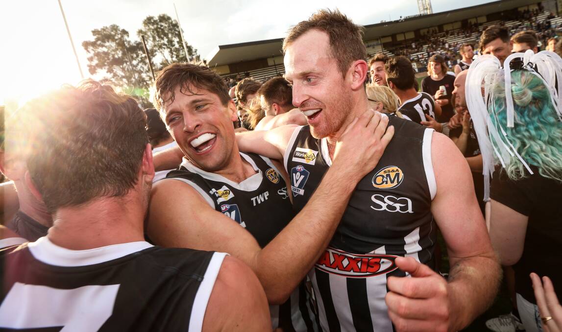 HAPPY DAYS: Magpie Ben Douthie embraces teammate Michael Newton after Saturday's epic win over Albury. Picture: JAMES WILTSHIRE