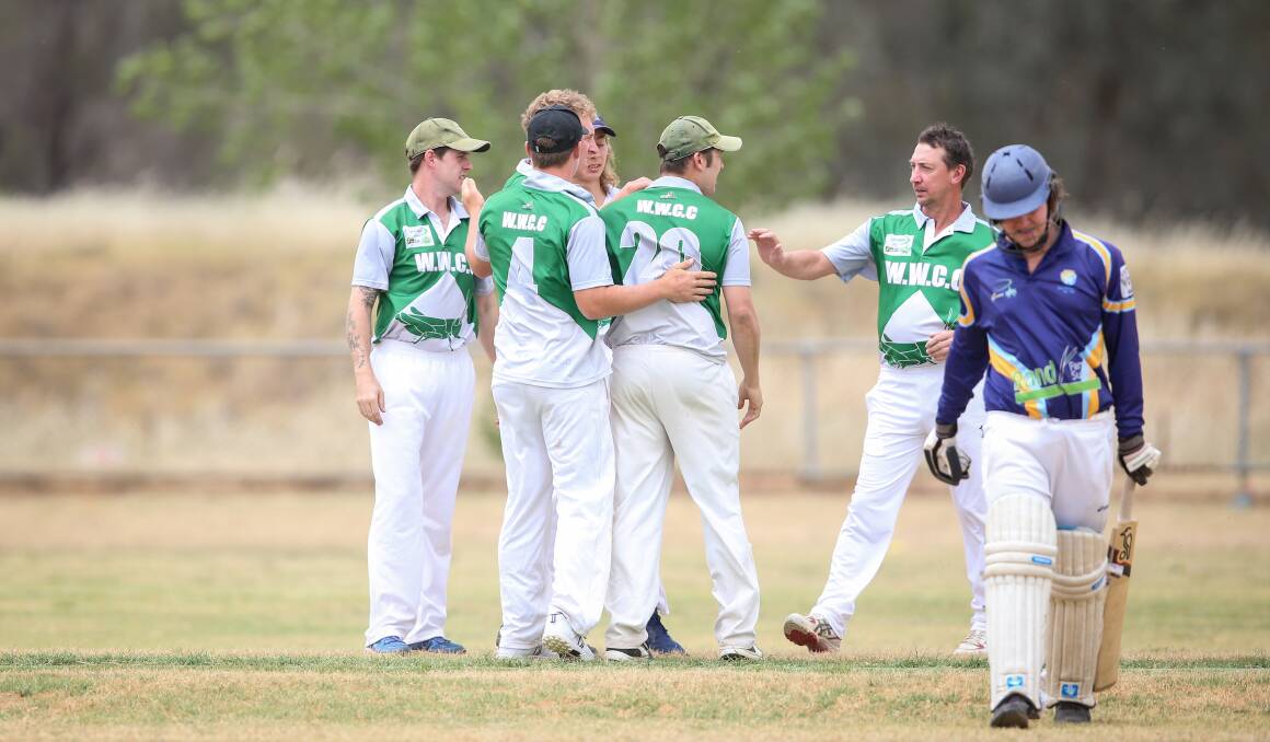 Hopper medium-pacer Joel Merkel is congratulated by teammates after taking the wicket of Brayden Lieschke in the first over of Saturday's match.
