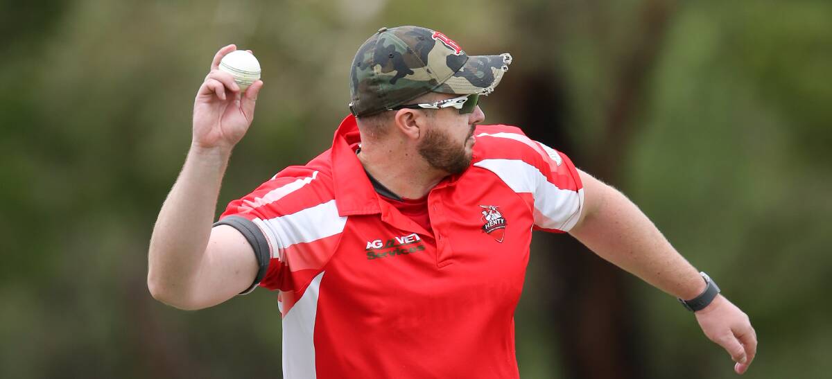 Richard Maher fires in a throw over the stumps for Henty in CAW Hume. The Lions won by 92 runs to jump into the top six.