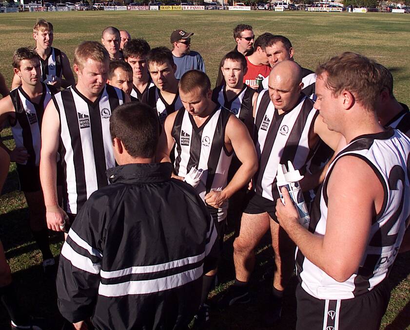 Ted Miller addressing his Murray Magpie players during a break at Urana Road Oval.