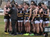 THREE IN A ROW: Murray Bushrangers coach Mark Brown talks tactics with his side during Saturday's clash against Bendigo. Picture: STEPHEN HICKS