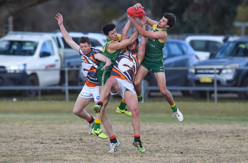 IN A TANGLE: Brothers Brendan and Tom Simmons do battle with Holbrook's Ben Talarico and Brad Carman. The Brookers won by eight points. Pictures: MARK JESSER