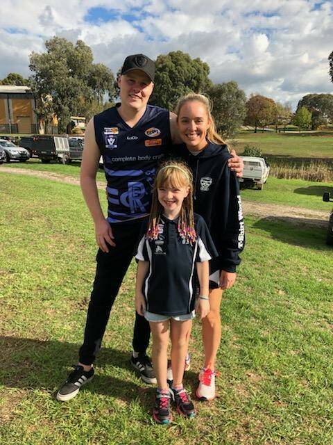Rutherglen footballer Ryan Jones with Cristy and Lucy Jacka ahead of Saturday's cancer awareness round match against Wodonga at Barkly Park.