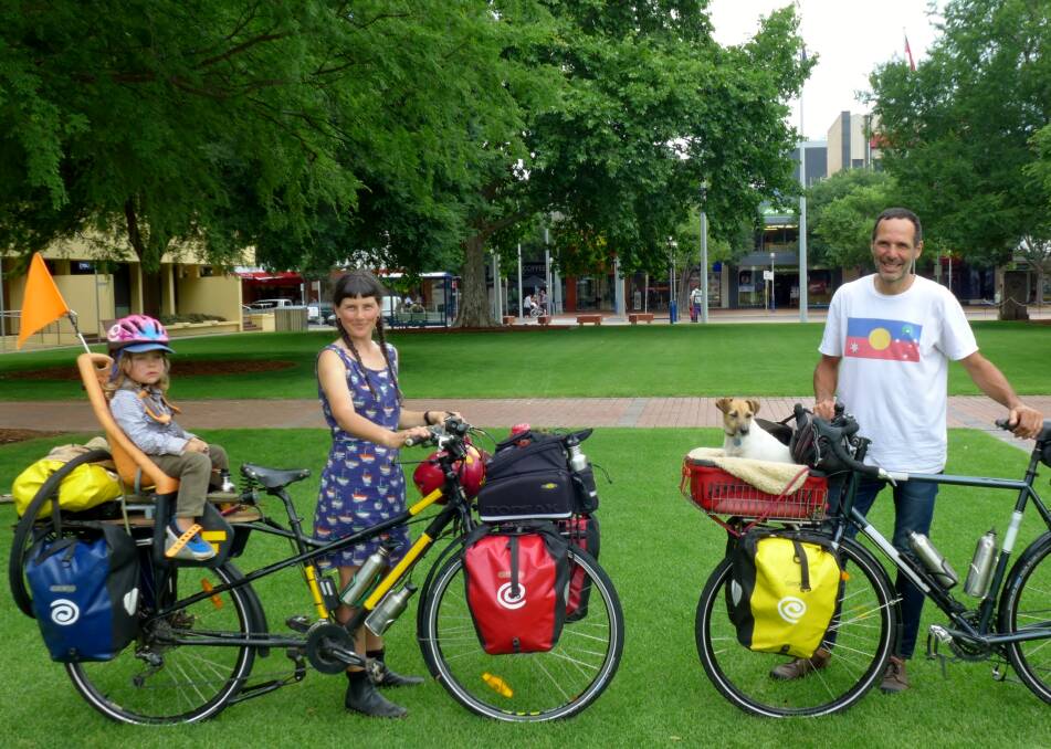 RIDE ON: Woody Ulman-Jones and parents Meg Ulman and Patrick Jones with Jack Russell Zero, cycled from Daylesford on their book tour.