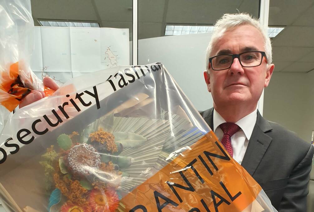 Independent Clark MHR Andrew Wilkie's with a quarantined floral arranged mailed to him by Facebook. Picture: Supplied
