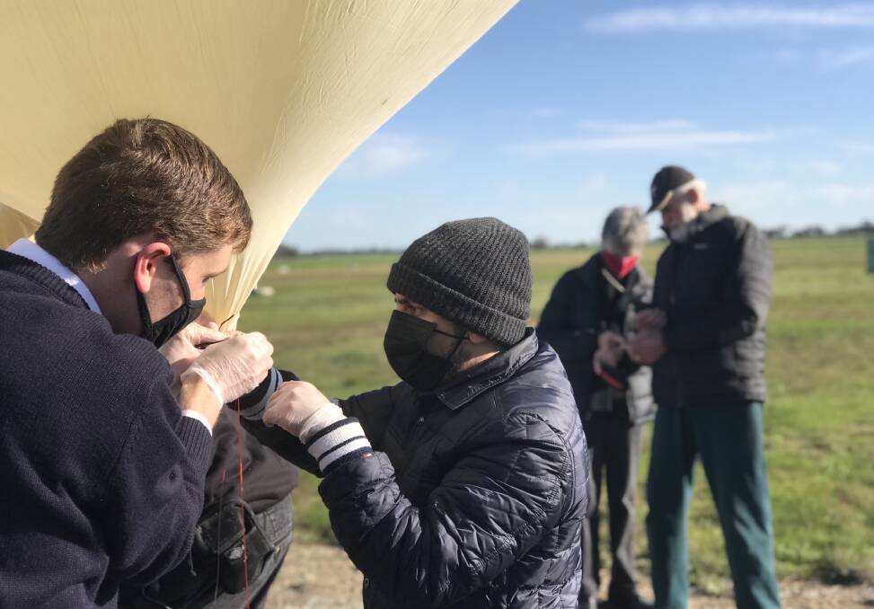 Scientists prepare to deploy a balloon during a test flight. Picture: SUPPLIED