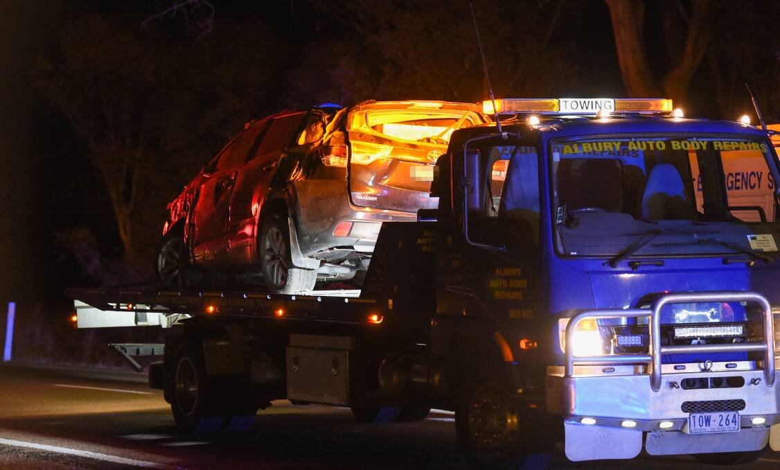 Awful sight: A tow truck removes the Toyota Kluger which Sue Churcher was driving at the time of Saturday's crash.