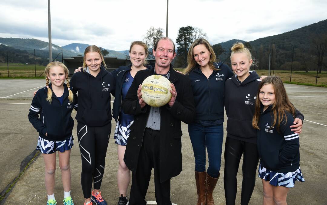 On the ball: Towong councillor Aaron Scales with Mitta United netballers and their Eskdale court which will benefit through spending contained in the shire's budget. 