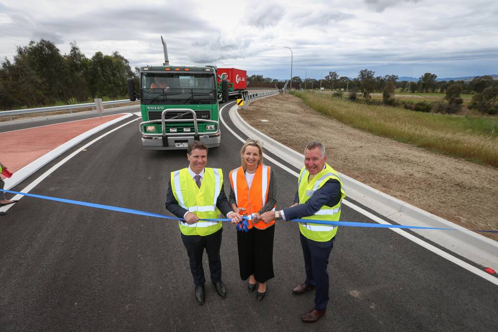 Big moment: Sussan Ley cut a ribbon alongside Justin Clancy and Kevin Mack as she opened the Davey Road ramps after construction began late last year.