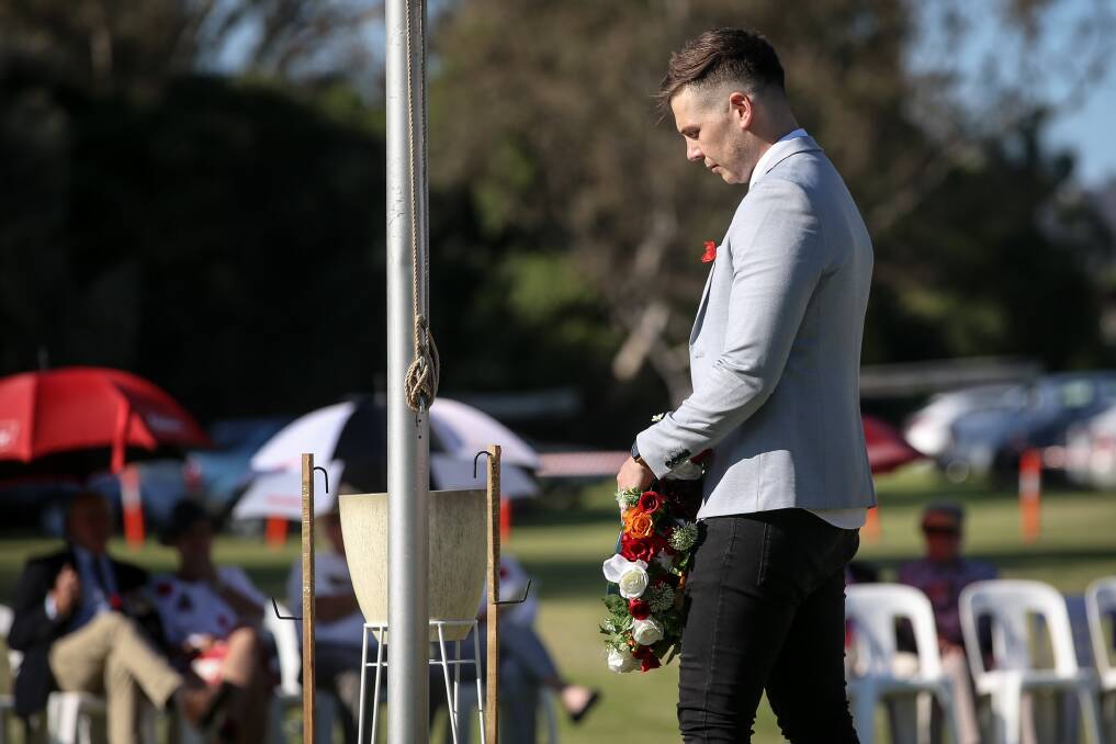 Poignant: Darcy Bishop deposits a wreath to salute his great grandfather Charles Bishop, a decorated World War I soldier buried in the pioneer cemetery. Picture: JAMES WILTSHIRE 