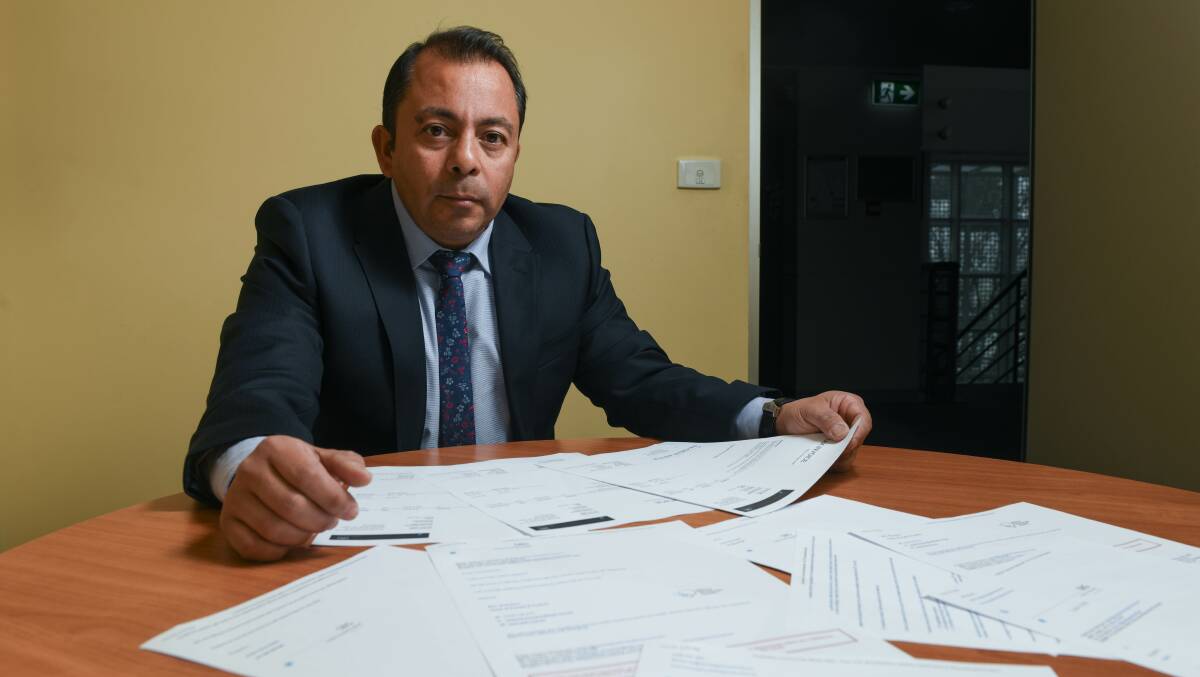 Synergy Personnel founder and chief executive Pedro Henriquez with copies of his company's invoices to Albury Wodonga Health and email correspondence. Picture by Tara Trewhella 