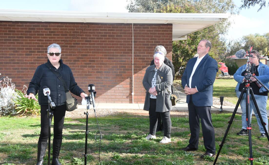 Judi Burke, whose son Kris lives at Merriwa Grove, addresses the media as Ovens Valley MP Tim McCurdy watches on. Picture by the Cobram Courier.