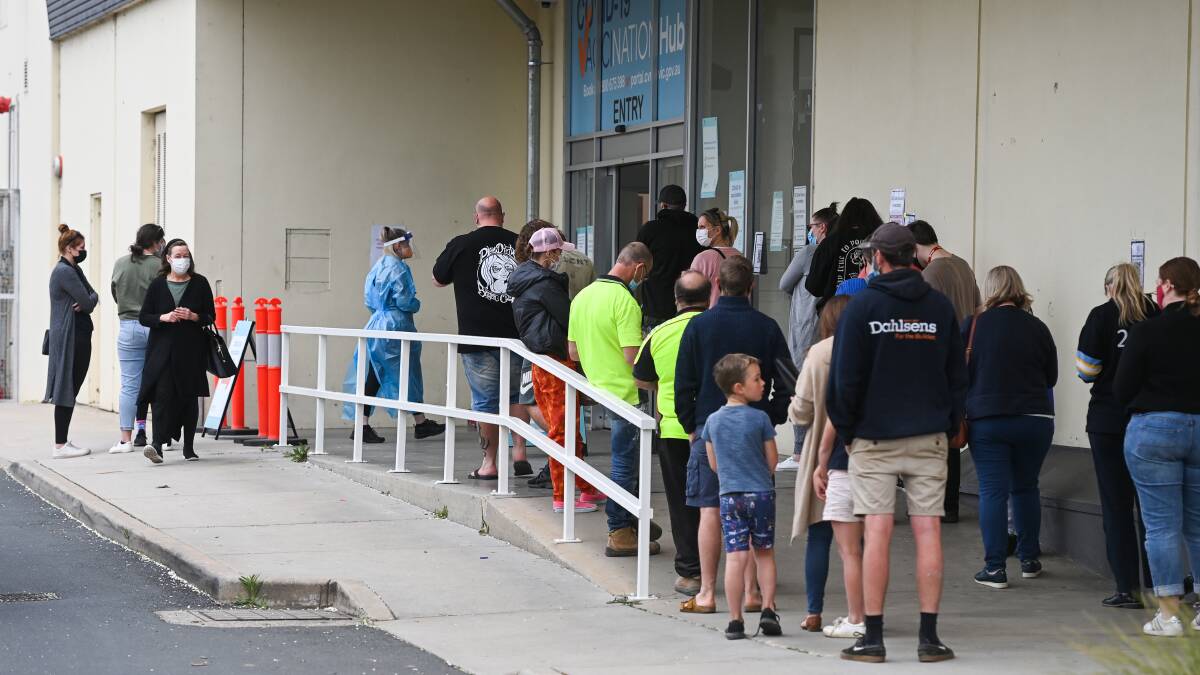 Strong turnout: Patients queue up in two lines outside Wodonga's vaccination hub on Friday for their COVID immunisations. Picture: ,MARK JESSER