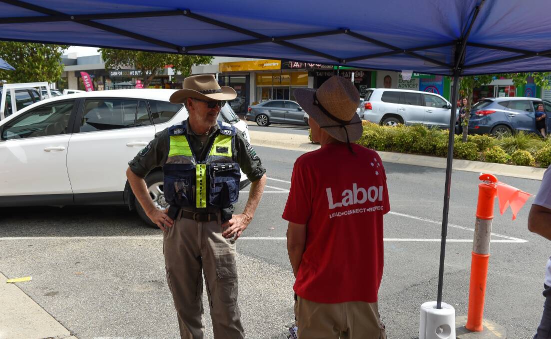 Questions raised: A Wodonga Council parking officer speaks to unionist Chip Eling, a supporter of Labor candidate for Benambra Mark Tait about a shade tent that extended on to High Street. Picture: MARK JESSER