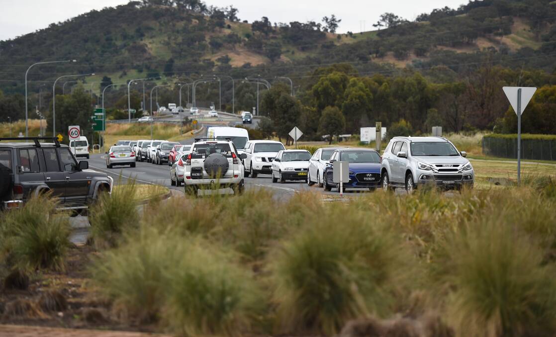 Changes ahead: Cars gather at the Thurgoona Drive-Elizabeth Mitchell Drive roundabout which will be replaced with traffic lights to cater to increased traffic volumes. Picture: MARK JESSER