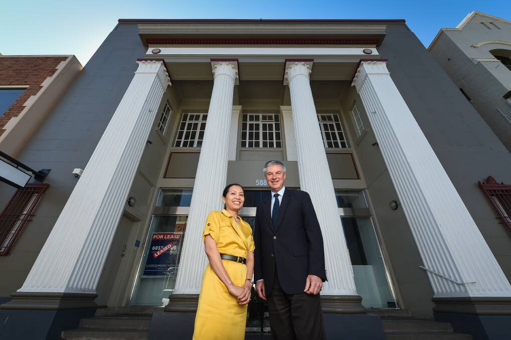 Changing use: Circa 1936 director Ririn Yaxley with member for Albury Greg Aplin outside the former Commonwealth Bank branch in Dean Street which is being turned into an exclusive hotel. Mr Aplin joined Tourism Minister Adam Marshall in announcing $150,000 in government funding for the project. Picture: MARK JESSER