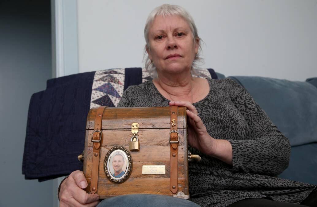 Memento: Kay Catanzariti with a chest featuring a photograph of her late son Ben. The box contains his ashes and has been taken to court hearings into his death.