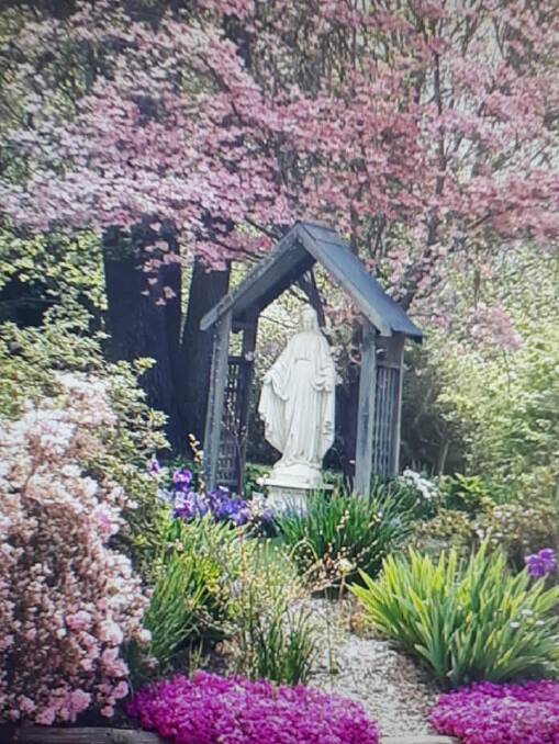 The way she was: The Virgin Mary as she appeared in the garden of Our Lady of the Snows church at Bright before vandals struck at the weekend. 