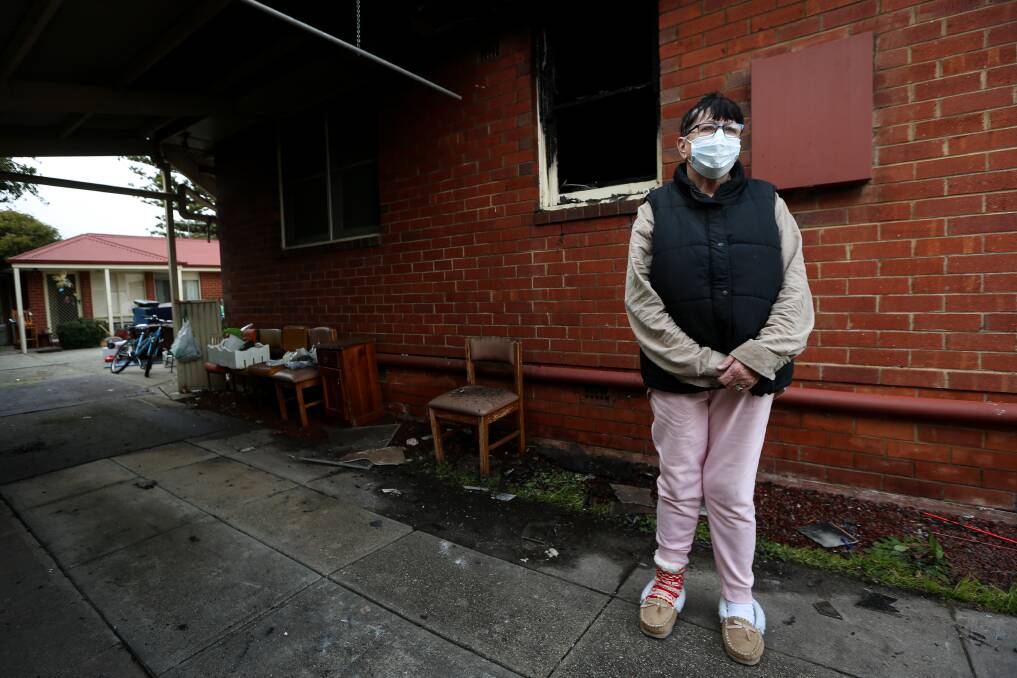 Dark night: Kerry Allen stands in front of the charred window frame which had flames erupt out of it on Sunday night. Her unit can be seen at the left of the photograph. Picture: JAMES WILTSHIRE