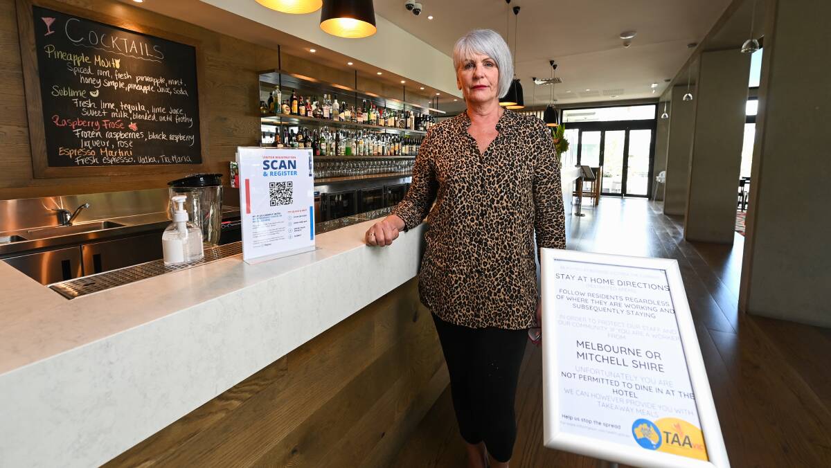 Pleased: Huon Hill manager Veronica Parker said she agreed wholeheartedly with a move to penalise disobedient Melbourne diners. A health warning to them is part of her COVID check-in area. Picture: MARK JESSER