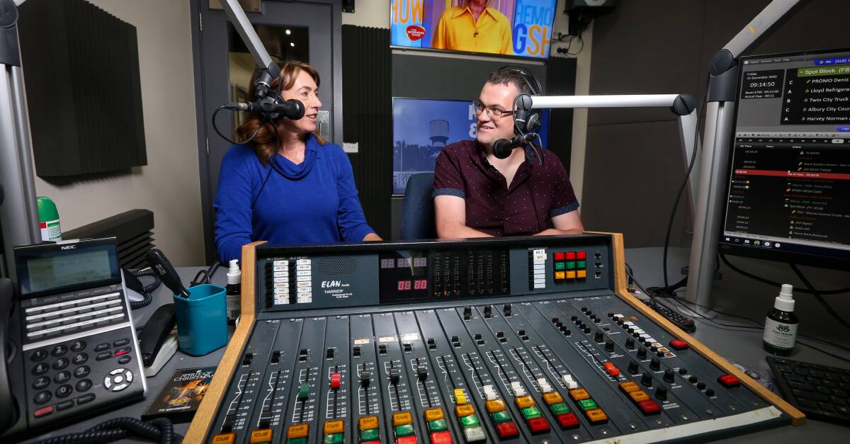 In their day jobs: Kylie King and Kev Poulton at their microphones for the 2AY breakfast program which they have presented for the past three years. They will return to the airwaves as joint mayors next week.