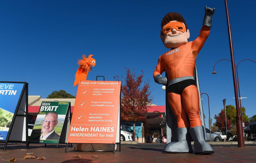 Look at me: Independent Helen Haines' orange bird meets Captain GetUp outside Wangaratta's early voting centre on Tuesday morning. Soon afterwards he took the XPT to Goulburn as part of his national tour before election day. Picture: MARK JESSER