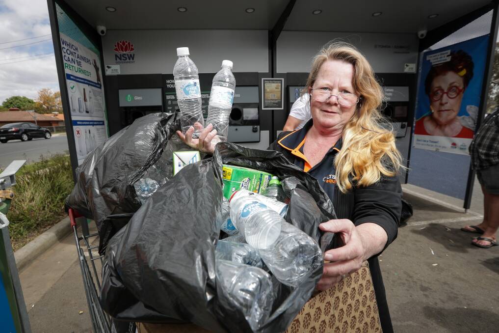 Recycler: Roslyn Mason with the water bottles she buys at Springdale Heights IGA with cash from container returns. Picture: JAMES WILTSHIRE