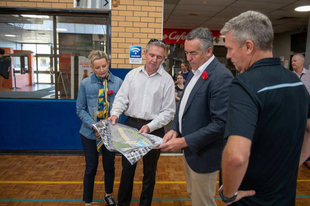 Albury Council deputy chief executive Brad Ferris points out the area earmarked for an aquatic centre to Darren Chester as Sussan Ley and the city's leisure facilities co-ordinator Peter Bauerle watch on. Picture by Tara Trewhella