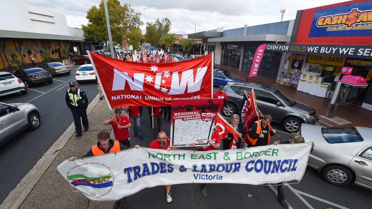 On the march: Unionists fill the northbound lane of High Street in Wodonga as they march from Woodland Grove to MP Cathy McGowan's office. Picture: MARK JESSER