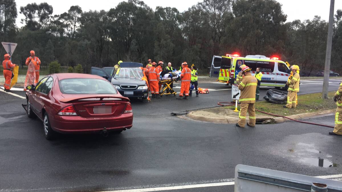 Extricated: Paramedics attend to the passenger after she was freed from her car following lengthy efforts by SES members.