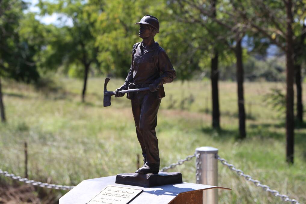 Tribute: A statuette of a firefighter stands above a plaque saluting the service of the late Samuel McPaul.